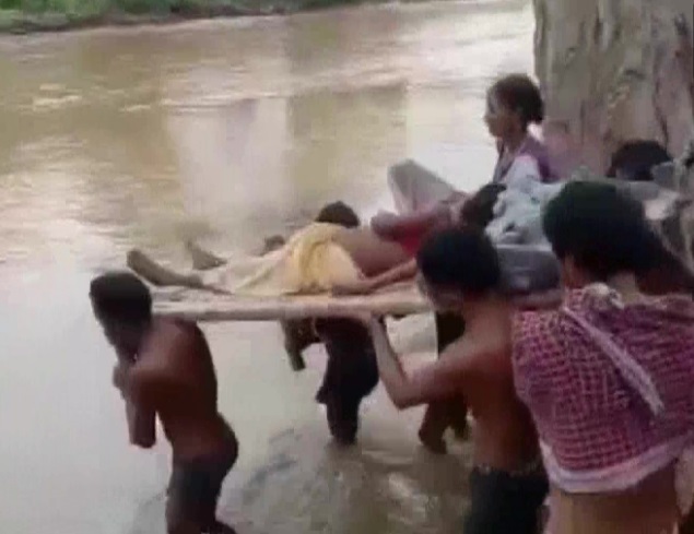 Villagers carry woman to hospital on cot after snake bite