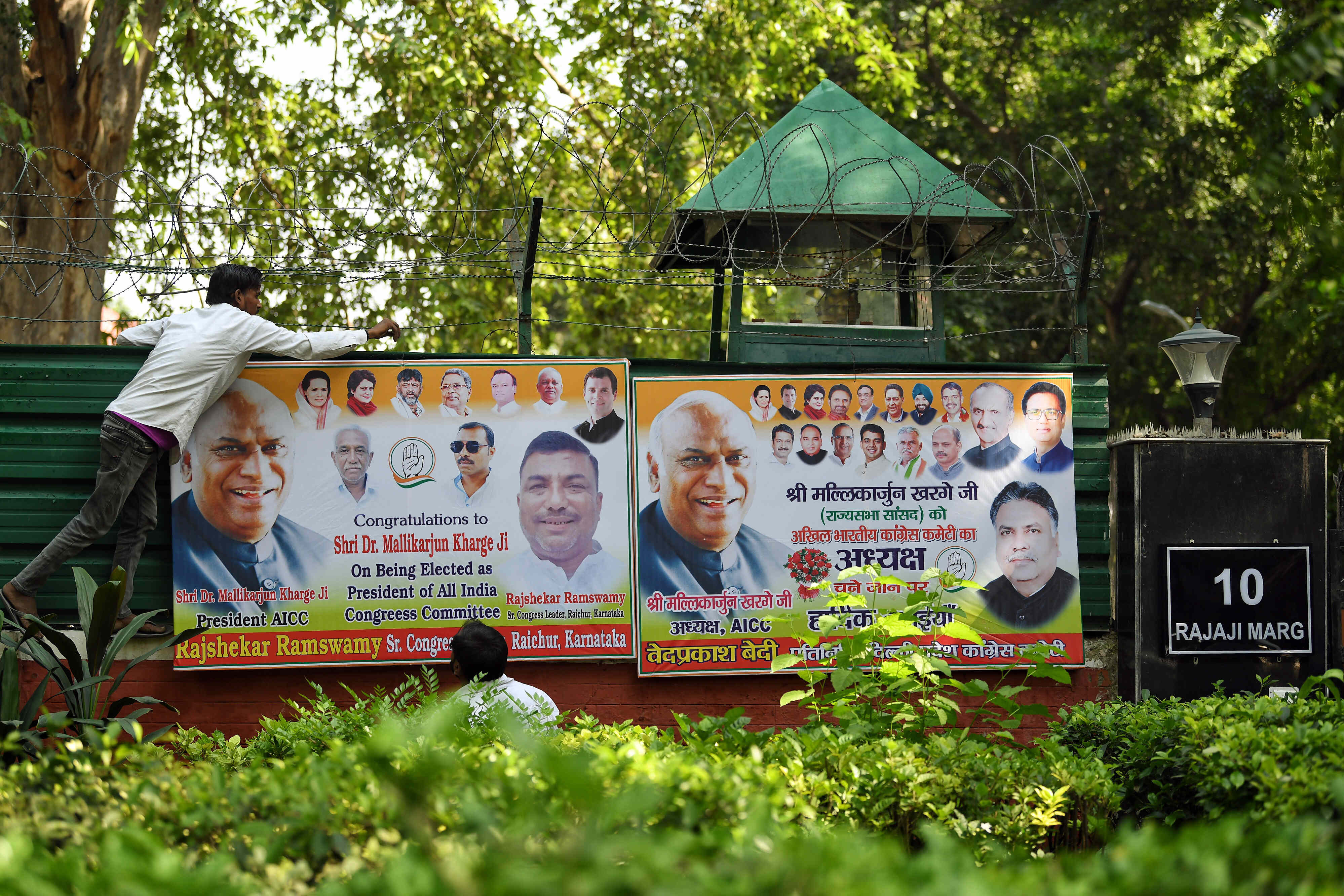 A banner being put up outside the residence of Congress Presidential candidate Mallikarjun Kharge following the announcement of his victory in the party's presidential elections