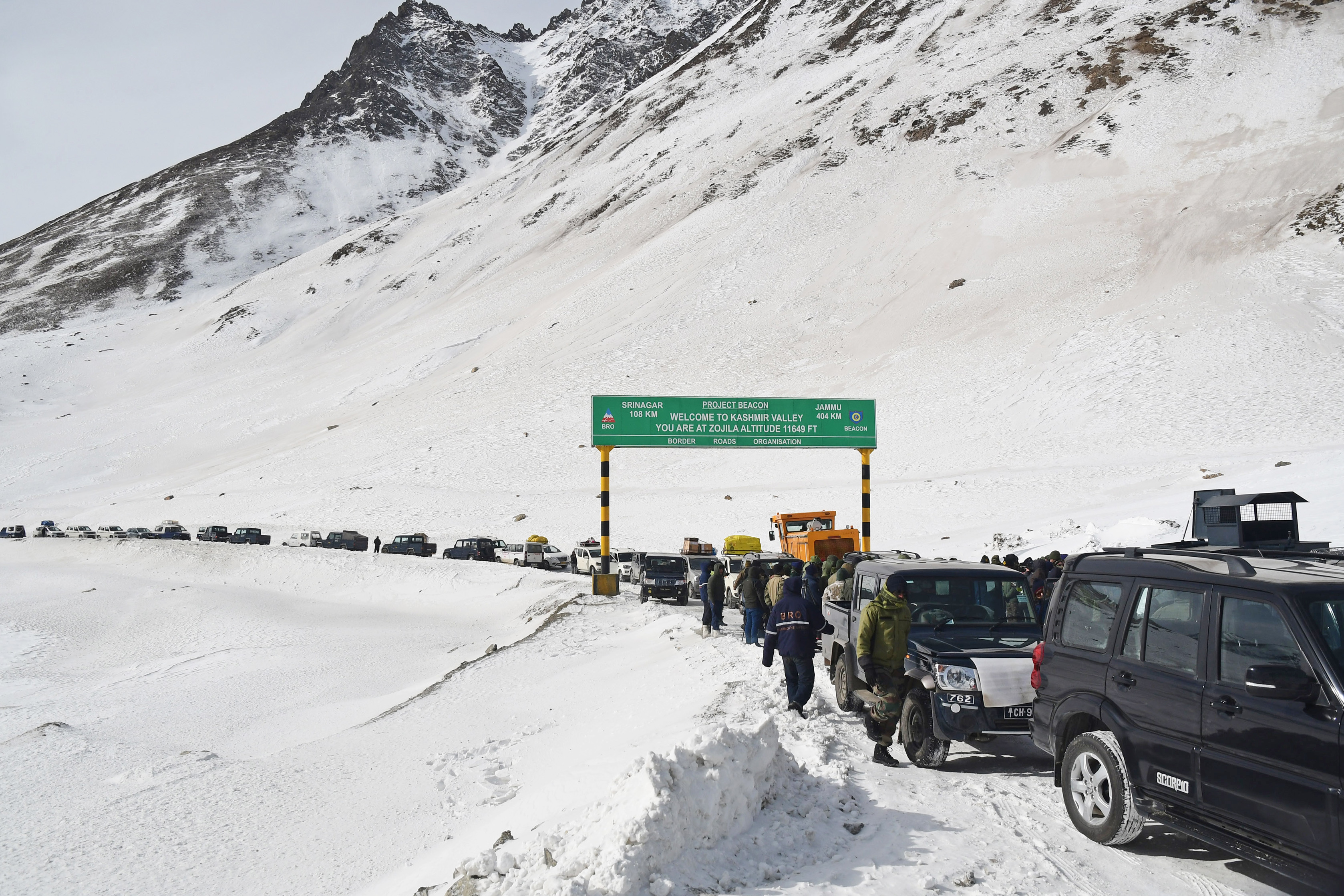 Vehicles queued up through snow-covered mountains on Srinagar-Leh Highway