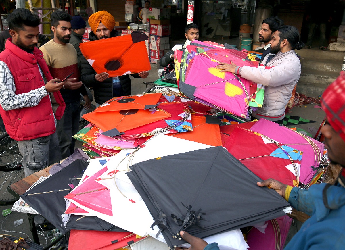 People shop for kites on the eve of Lohri festival