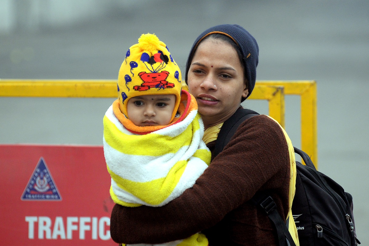 Cold Wave: A woman and her child protecting themselves from harsh winter