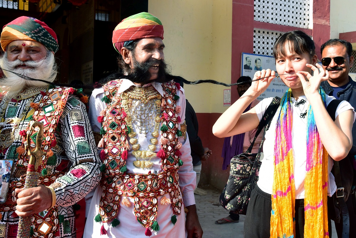 A Rajasthani artist showing his long moustache to entertain tourists in Bikaner