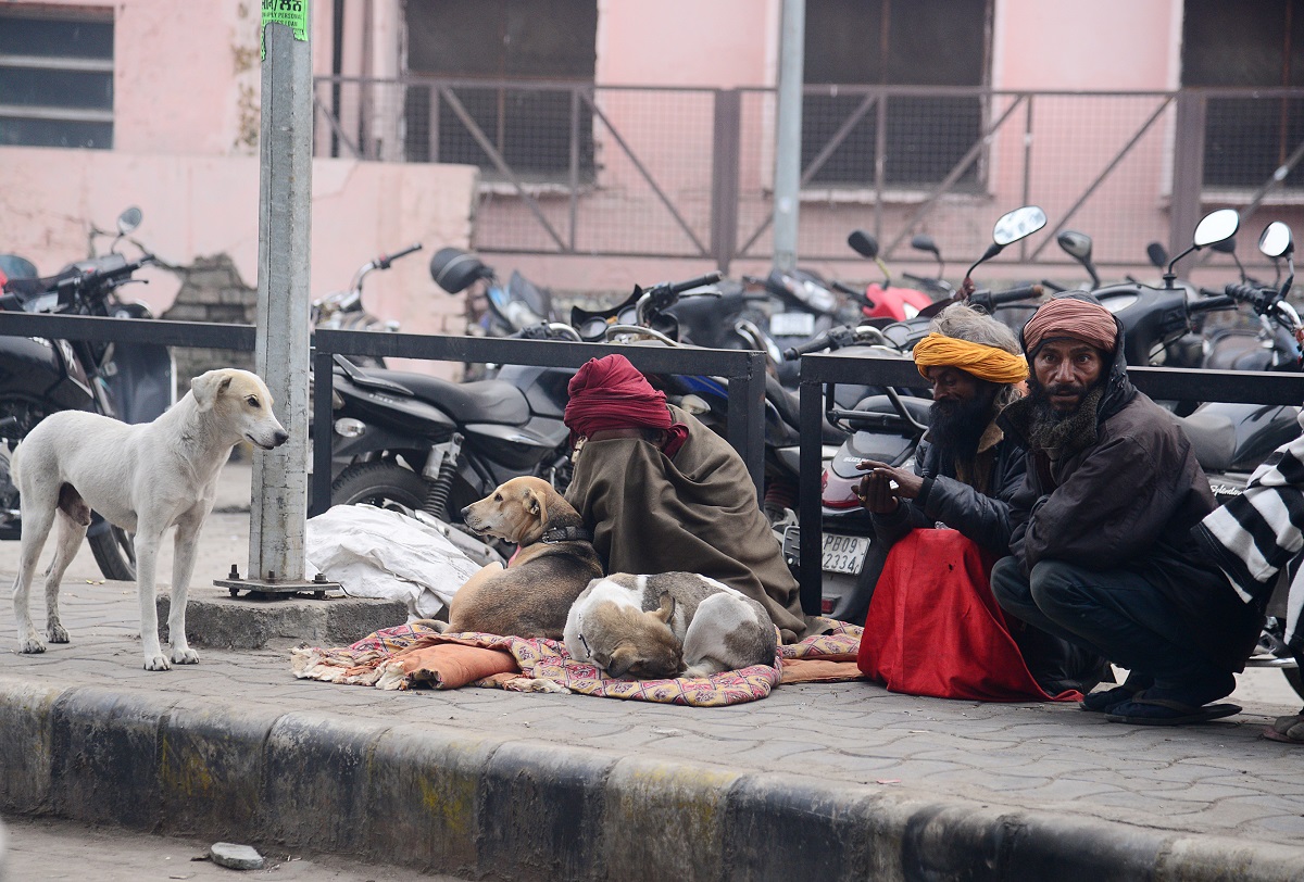 Winter Horror: Homeless people sit along a roadside on a cold winter day