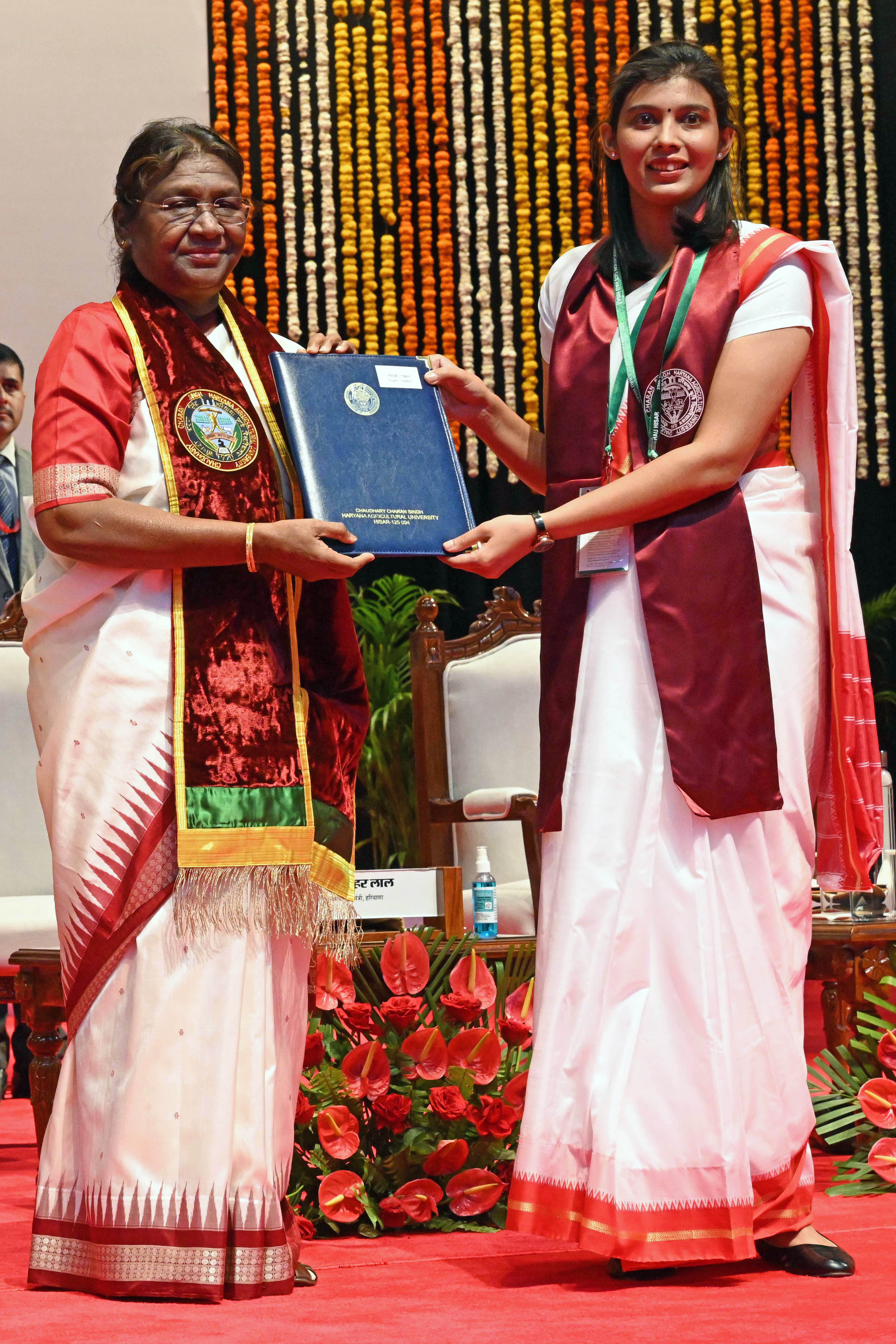 President Droupadi Murmu hands over a degree certificate to a student during the 25th convocation of Chaudhary Charan Singh Haryana Agricultural University, in Hisar.