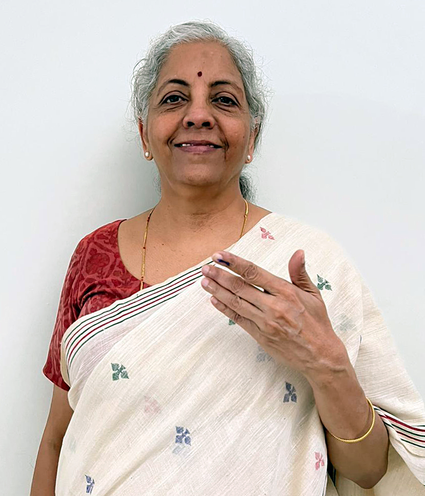 Union Finance Minister Nirmala Sitharaman shows ink-marked finger today after casting vote in Karnataka at Bharath Education Society polling booth in Bengaluru