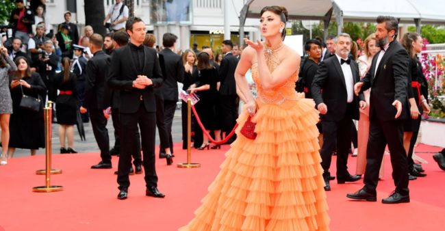 Urvashi Rautela dazzles at Cannes in orange frill gown with a touch of pearl