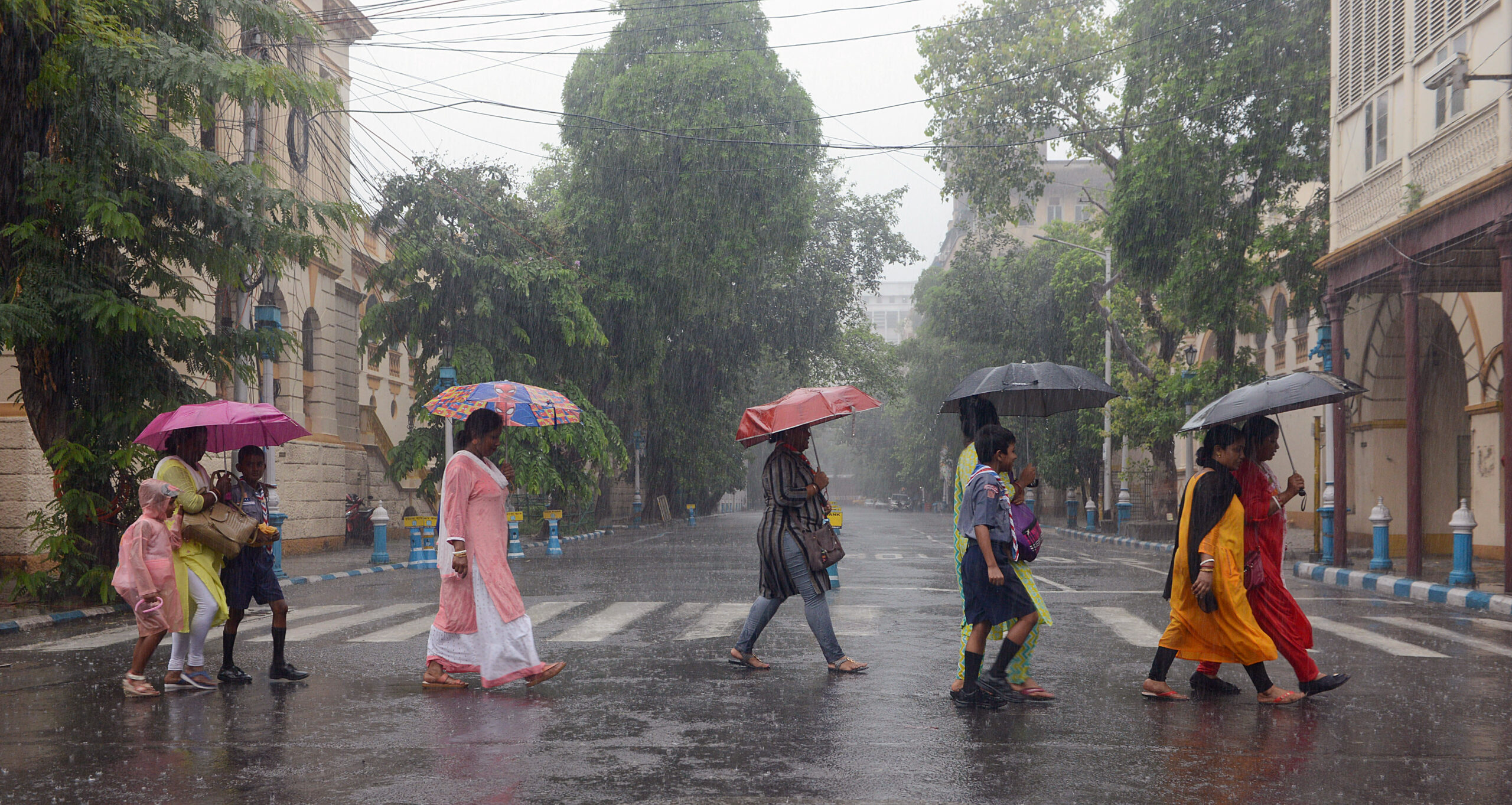 Students along with their parents during rainfall in Kolkata