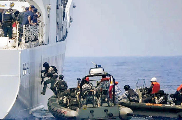 Heavily armed US Coast guard personnel board vessel in South china sea drill