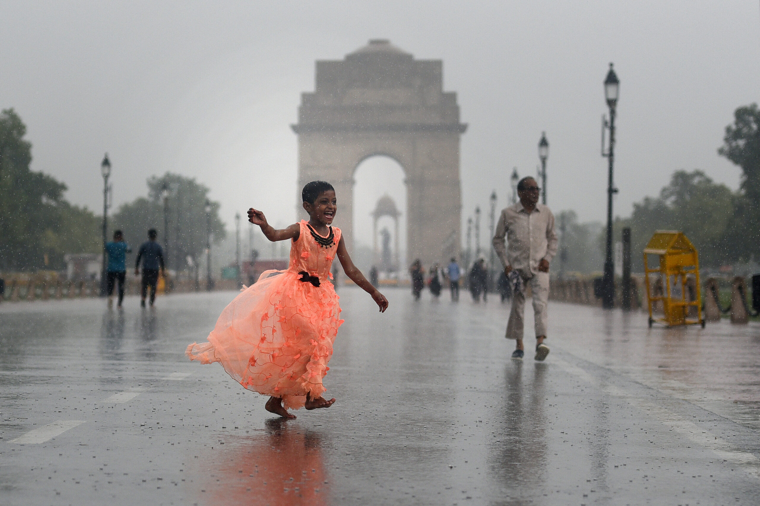 A child enjoys the light showers of rain