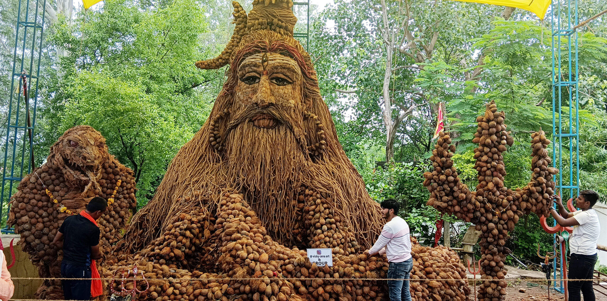 Artists make an idol of Lord Shiva using coconuts during the month of Sawan