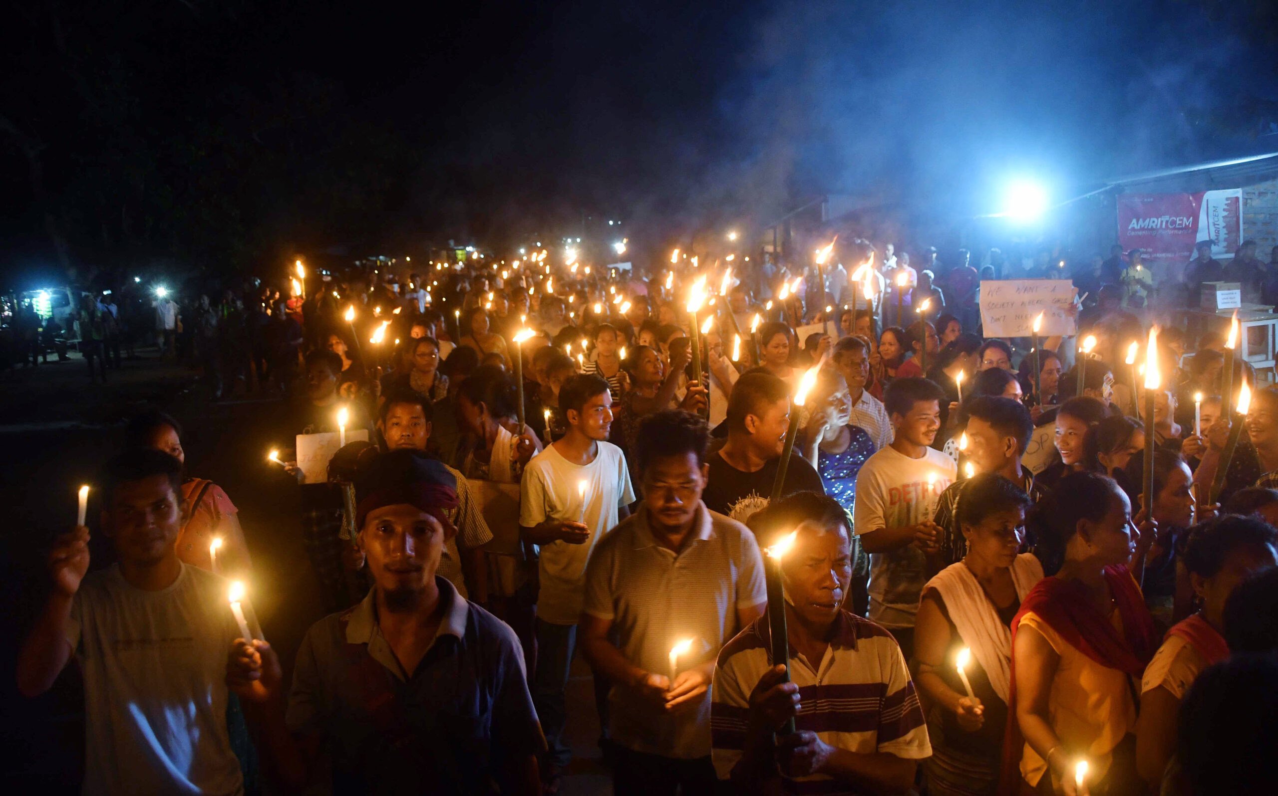 Members of the Ranglong Youth Association take part in candlelight march