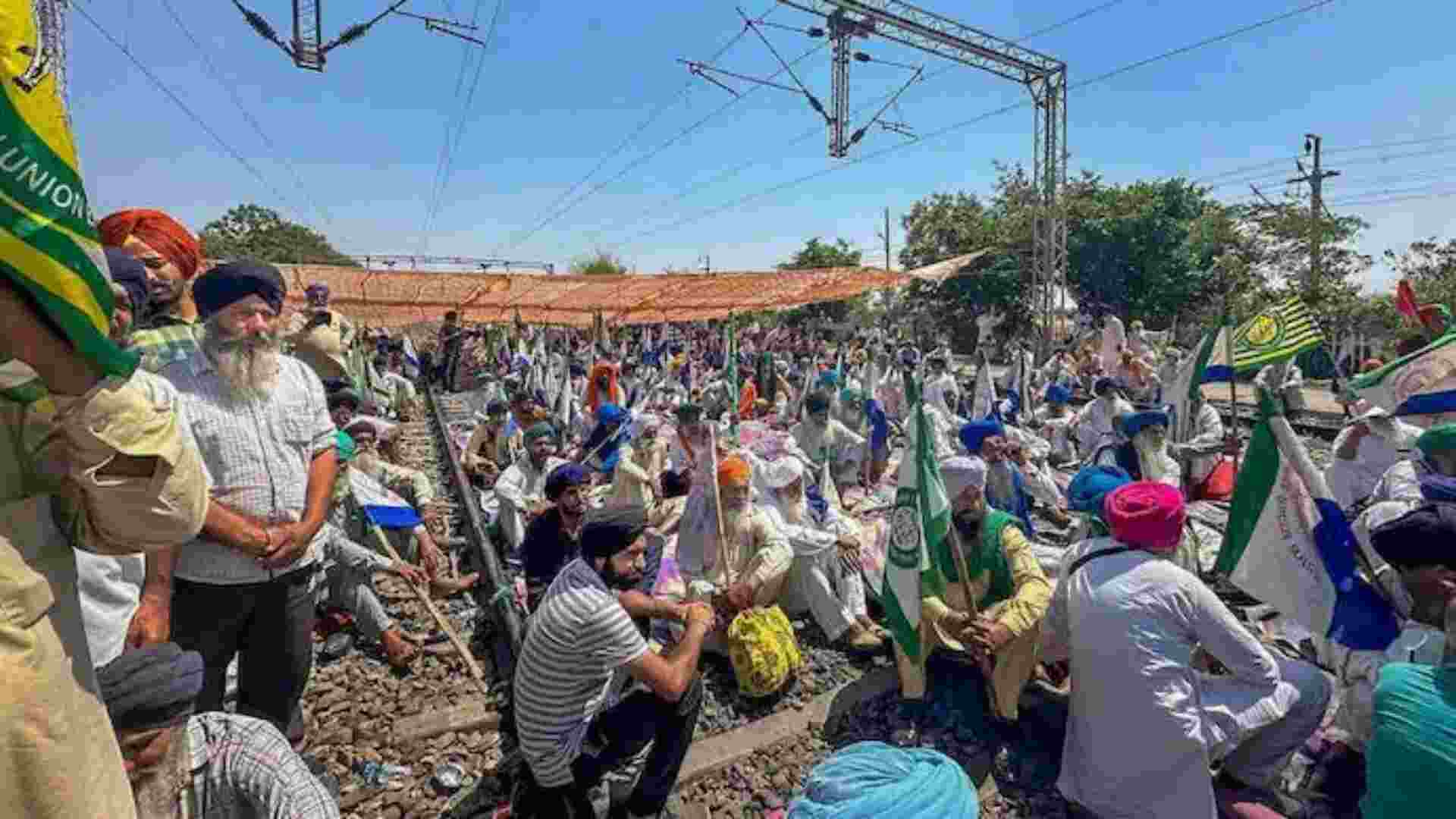 Protestors sit at the Ambala-Amritsar route