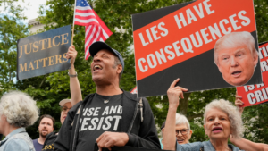 Demonstrators hold placards outside the Manhattan criminal court 