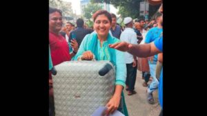 See Viral Photo: Woman In Dior Suitcase Smiles Amid Sheikh Hasina’s Residence Loot