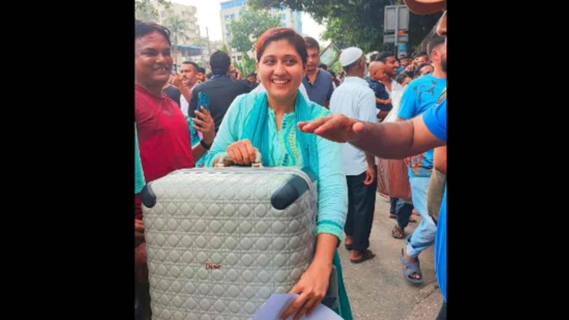 See Viral Photo: Woman In Dior Suitcase Smiles Amid Sheikh Hasina’s Residence Loot