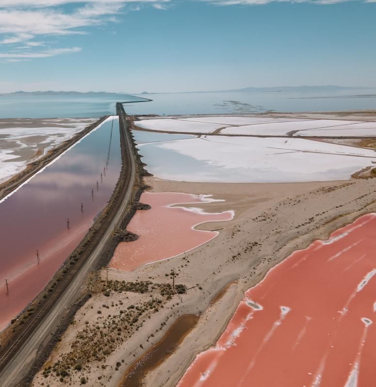 Aerial view of the Great Salt Lake’s salt flats and pinkish hue in Utah. - Photo Gallery