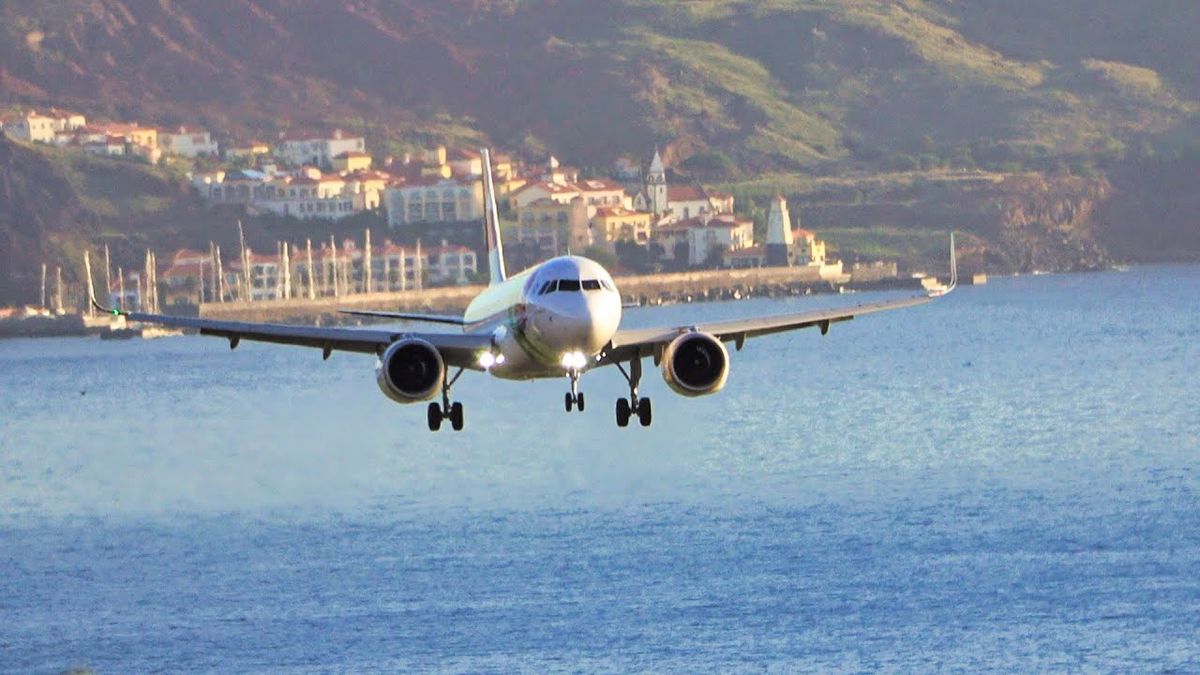 Madeira runway perched between cliffs and ocean waters. - Photo Gallery