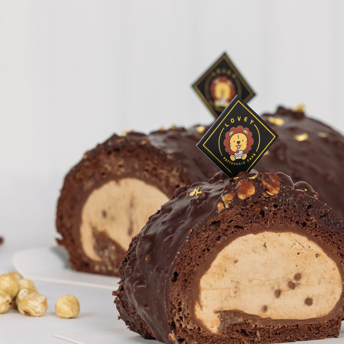 Slices of creamy gianduja chocolate with hazelnuts on a rustic plate. - Photo Gallery
