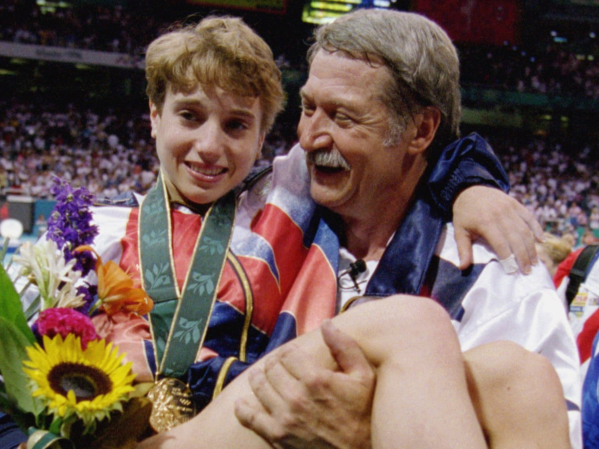 Coach Bela Karolyi carrying Kerri Strug after her vault at the 1996 Olympics. - Photo Gallery