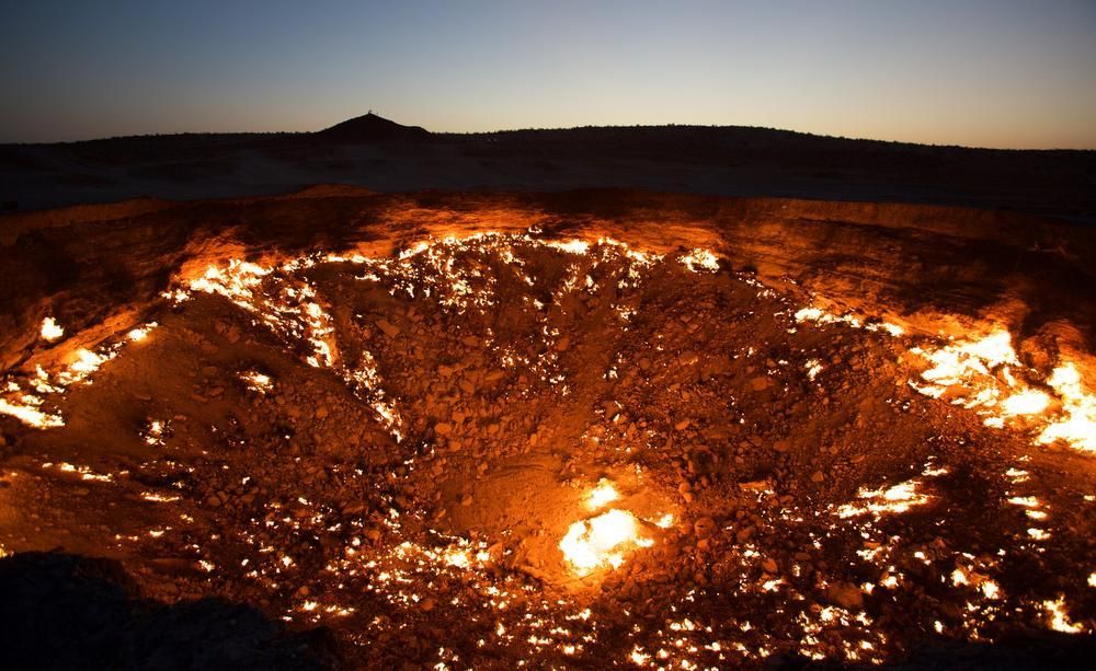 Fiery crater of the Door to Hell glowing bright orange against - Photo Gallery